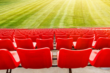 Red seats and green grass in the stadium