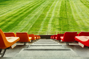 Red seats and green grass in the stadium