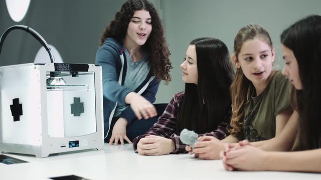 Five Children working with 3D printer at school