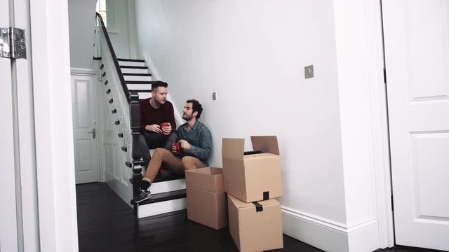 Same Sex Couple Moving In New House, Drinking Coffee