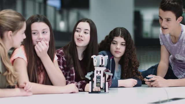 Five Children working with small robot at school
