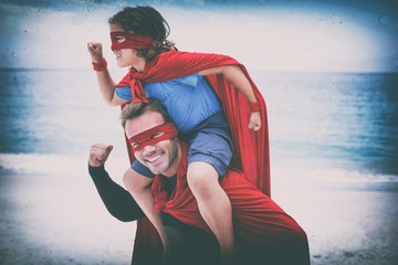 Father and son in superhero costume pretending to run