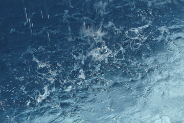 Rain Drops falling into a Pool of Water