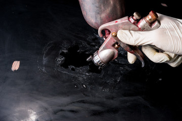 Worker paint with spray gun