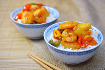 sweet and sour shrimp. deep fried crispy prawn stir fried with pineapple and fresh capsicum in sour and sweet sauce. worldwide famous chinese cuisine.