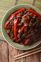 Eggplant Stir-Fry from Asian-style close-up on a plate. vertical top view
