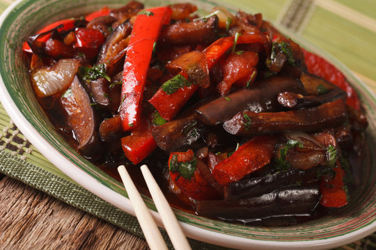 Eggplants fried with vegetables in a Korean-style close-up. horizontal
