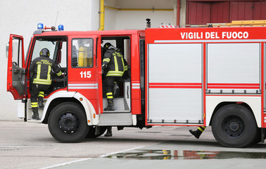 Fototapeta premium fire engine carrying two firefighters