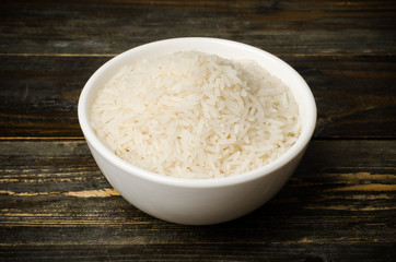  Rice seed in the bowl on wooden background