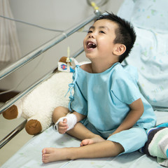 A sick Little boy in hospital bed.