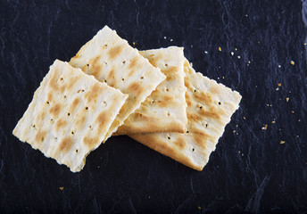 Crackers over black stone background
