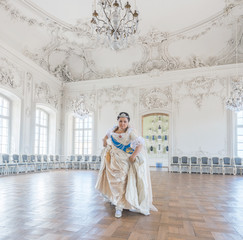 Historical cosplay. Beautiful woman in the similitude of Catherine the Great, empress of Russia ancient dress in the palace