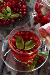 berry tea in cup on dark wooden table