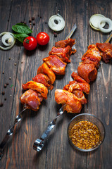 Raw shashlik from pork ready to cook on wood plate