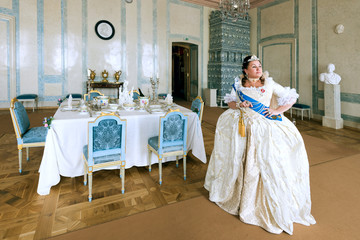 Historical cosplay. Beautiful woman in the similitude of Catherine the Great, empress of Russia ancient dress in the palace