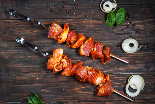 Raw shashlik from pork ready to cook on wood plate