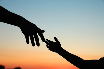 Fototapeta na wymiar silhouette parent and child hands