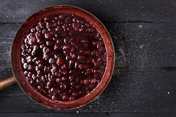 Fresh strawberries into rustic brass bowl
