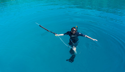 underwater hunter with a gun in a mask. speargun