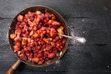 Strawberries mixed with sugar left for juice release