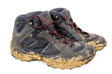 Close-up of muddy shoes after a hike on the mountain.