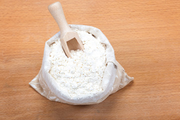 Flour in a canvas bag and wheat ears.