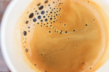 Coffee foam texture close up in cup.