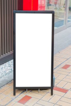 Blank white board stand on the storefront.