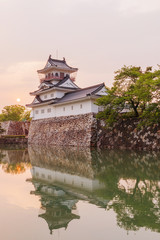 Fototapeta na wymiar Toyama castle with beautiful sunset and reflection in water.