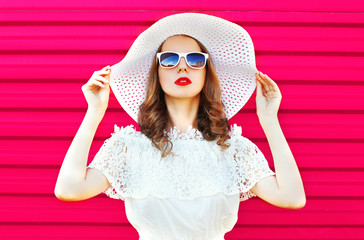 Fashion portrait pretty woman in white summer straw hat over col