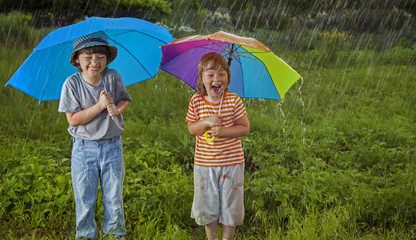 happy brother with umbrella outdoors