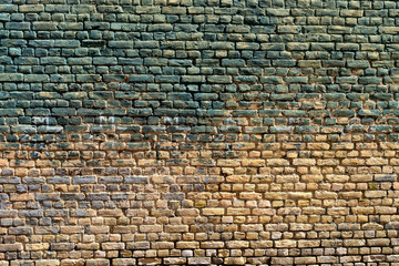Old brick wall with traces of paint