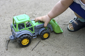 Fototapeta premium The child plays with the excavator.