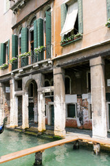 Fototapeta na wymiar Venetian narrow canal among classical shabby houses