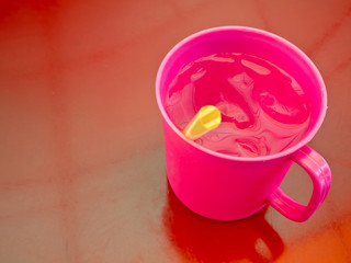 Cool water in plastic cup at street food shop