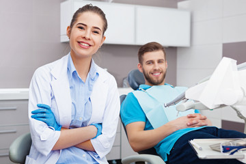 Portrait of a female dentist and young happy  male patient.