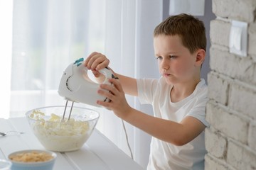 Child mixing with electric mixer white cottage cheese