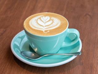 cup of coffee on wood table
