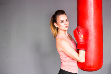 Young woman with punching bag
