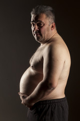 Fototapeta premium fat shirtless man posing in the studio