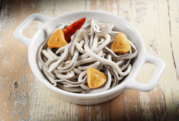 artificial elvers in garlic sauce