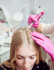 Fototapeta premium Beautician and the patient in the clinic of aesthetic medicine.