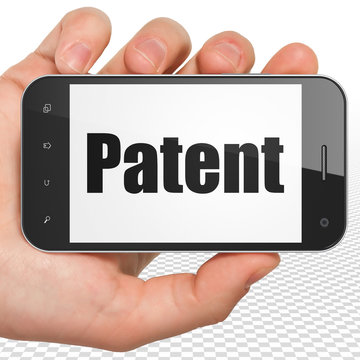 Law concept: Hand Holding Smartphone with Patent on display