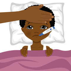 little african american boy ill in bed with thermometer in his mouth and mother s head on his forehead