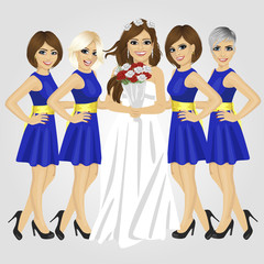 Beautiful bride in wedding dress holding bouquet of roses posing with group of her bridesmaids
