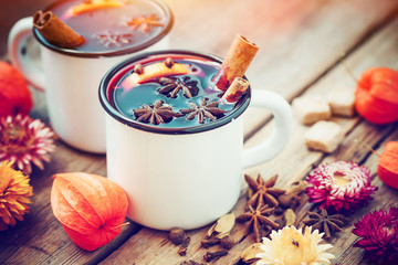 Mulled wine in mugs, spice and dry flowers. Autumn still life.