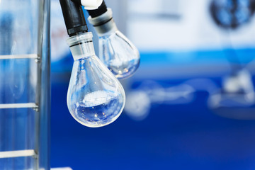 Glass bulb on a rotary laboratory evaporator. Industrial background.