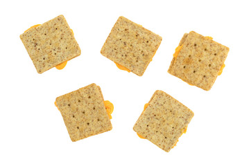 Cheese between whole wheat crackers on a white background top view.