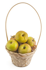 Bunch of raw organic domestic Serbian kožara apples in wooden basket, isolated on white background