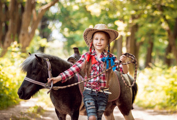 Beautiful little girl on a pony.